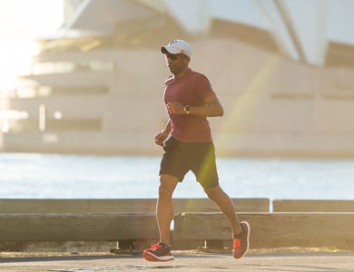 Man running in front of Sydney Opera House