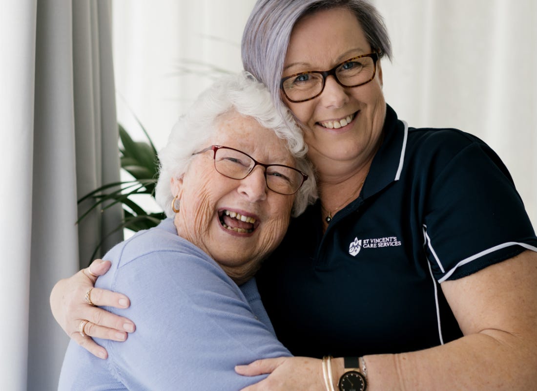 A St Vincents carer embracing her elderly patient