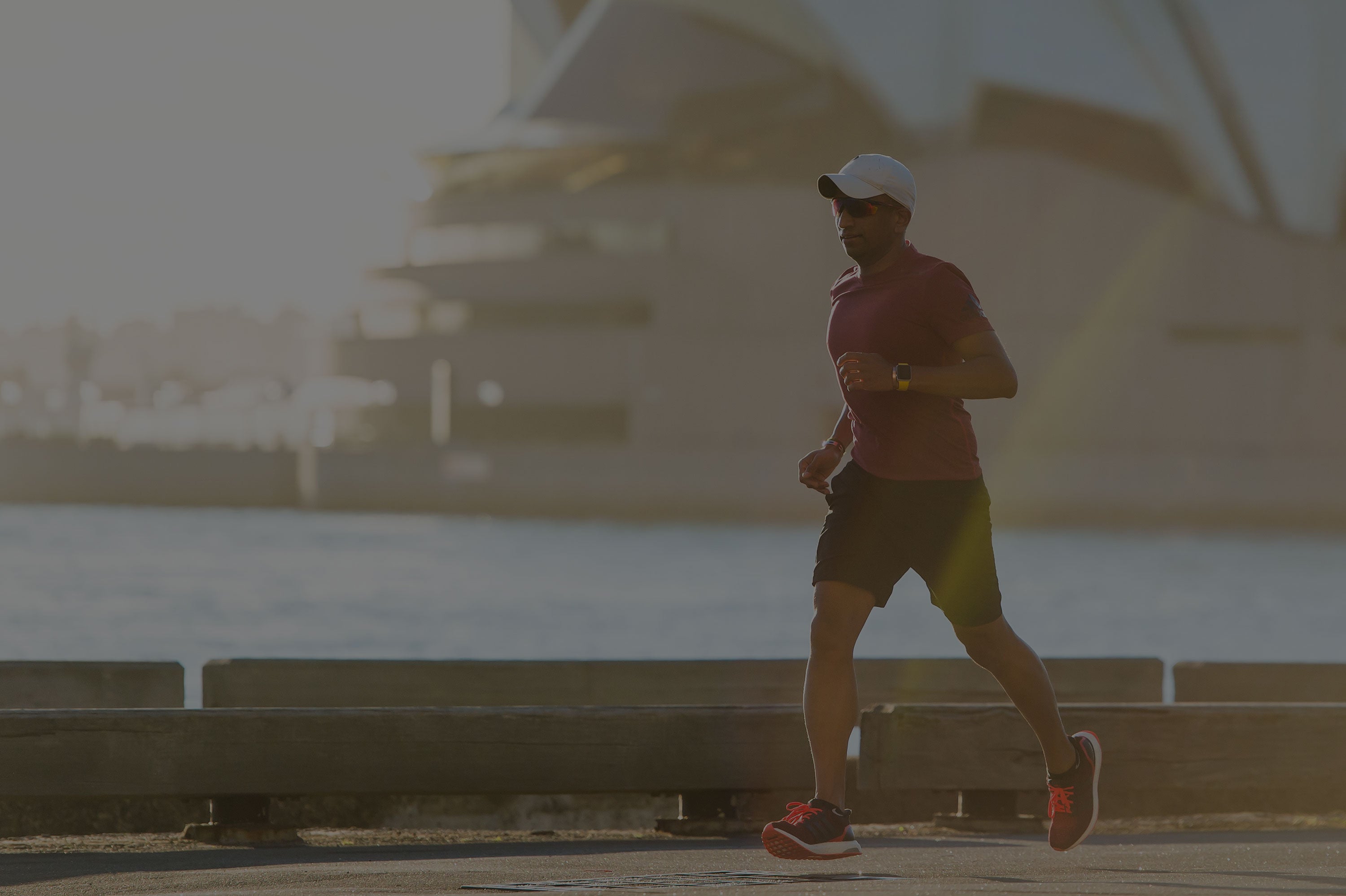 Man running in front of the Sydney Opera House