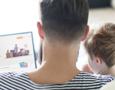 Father and son browsing Goodstart at Home on a laptop