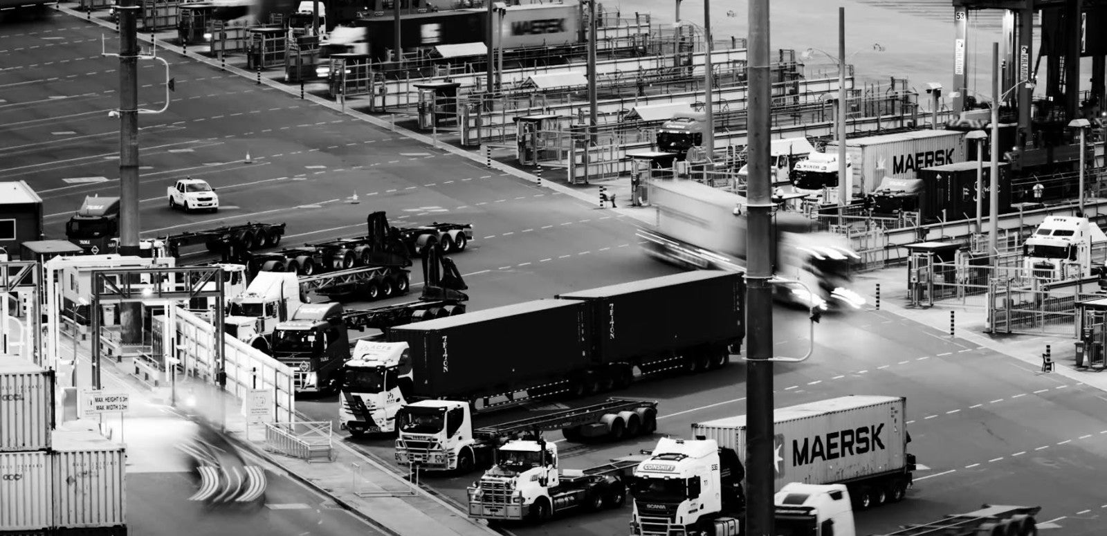 Photo of a busy port with transport trucks