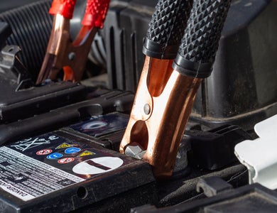 Jumper cables attached to a car battery