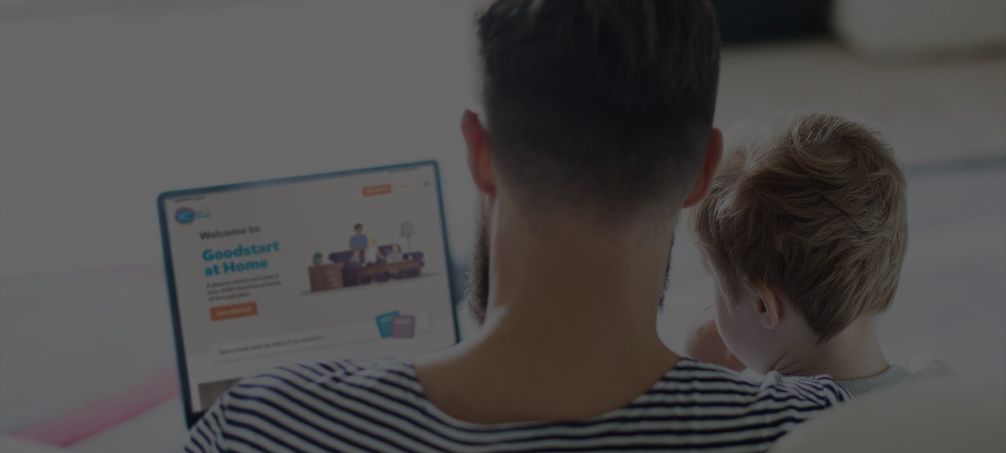 Father and son browsing Goodstart at Home on a laptop