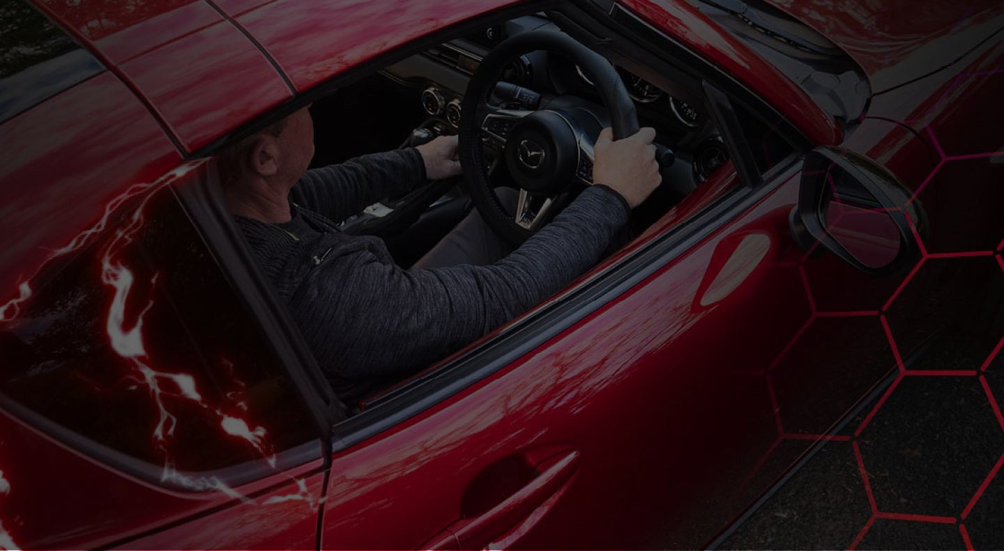 Driver sitting in a red sports car