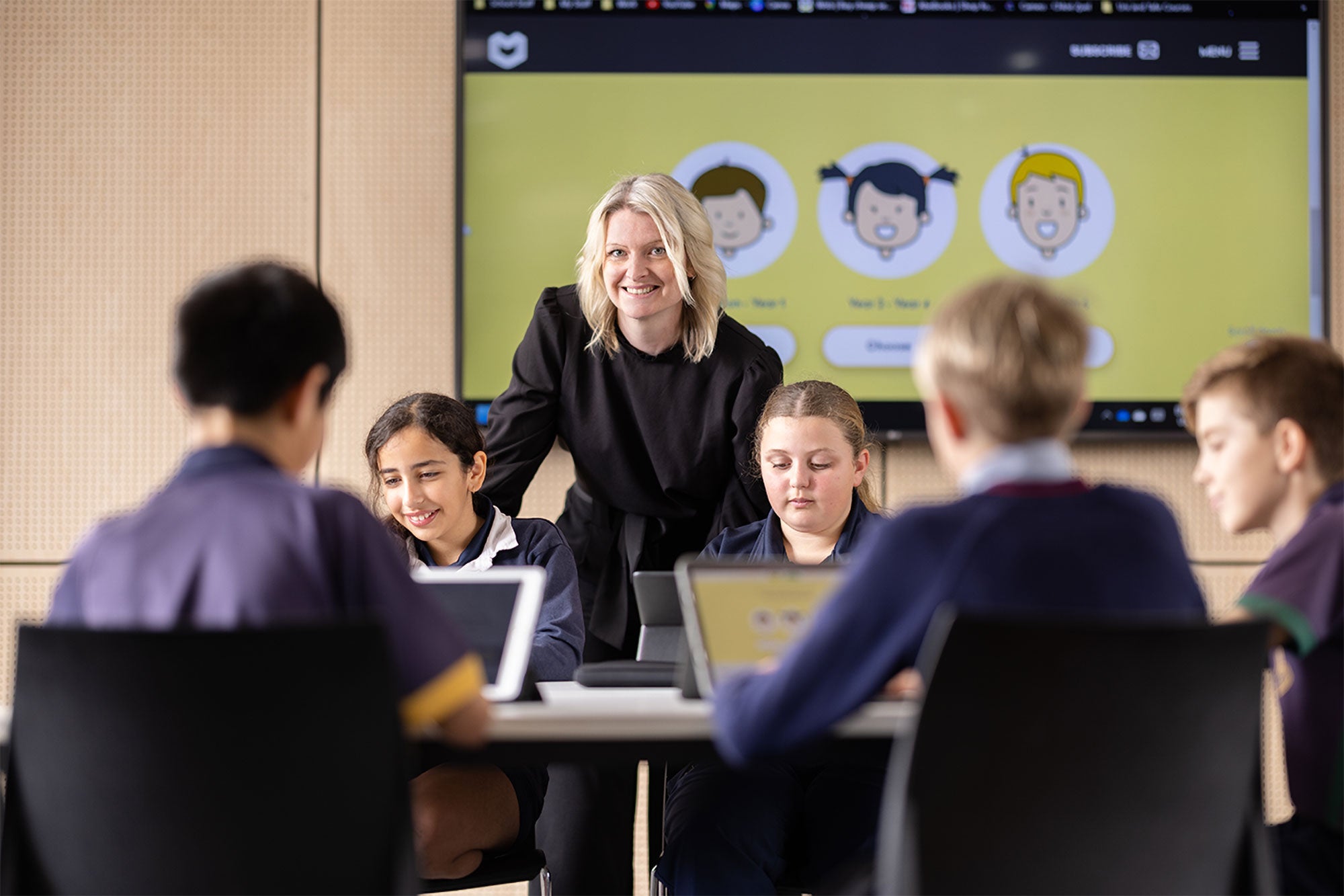 Confident teacher in the classroom using ESA's products