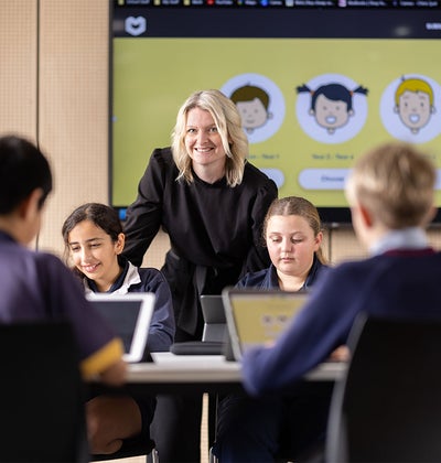 Confident teacher in the classroom using ESA's products